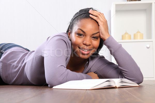 Time out student girl looks up from reading book Stock photo © darrinhenry