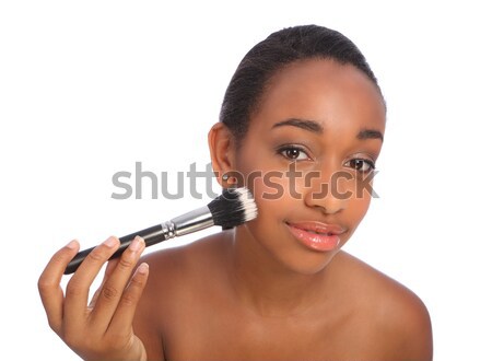 Stock photo: Beautiful black woman using make up powder brush