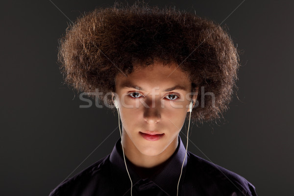 Music and bushy afro hairstyle on teenager boy Stock photo © darrinhenry