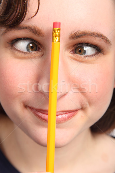 Funny cross eyes of woman with pencil on her nose Stock photo © darrinhenry