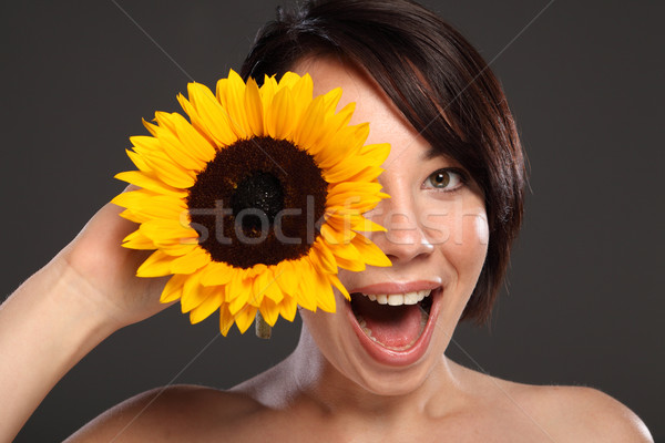 Beautiful happy young girl sunflower to her face Stock photo © darrinhenry