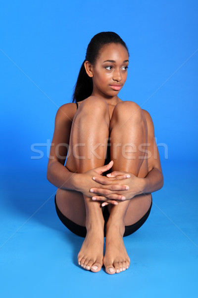 Young black woman in underwear hugging legs Stock photo © darrinhenry