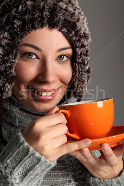 Beautiful girl in warm wool hat drinking tea Stock photo © darrinhenry