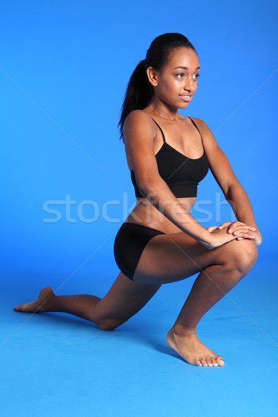 Kneeling hip flexor stretch by African woman Stock photo © darrinhenry