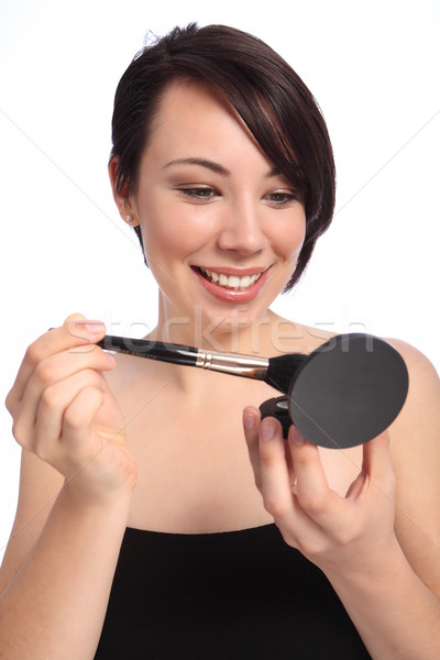 Make up using cosmetic compact and blusher brush Stock photo © darrinhenry