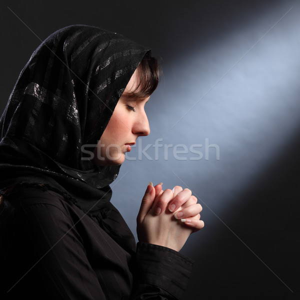 Moment of quiet faith as young woman prays Stock photo © darrinhenry