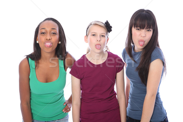 Ethnic teenage girl friends fun tongues out Stock photo © darrinhenry