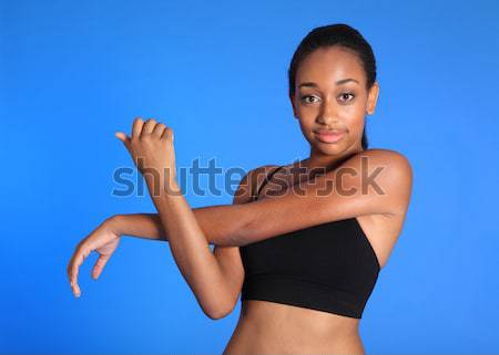 Hamstring and back stretch by pretty African woman Stock photo © darrinhenry