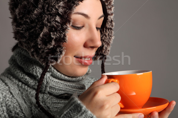 Young woman in warm winter hat drinking hot tea Stock photo © darrinhenry