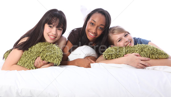 Stock photo: Mixed race teenage girl friends at slumber party