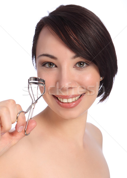 Smile by beautician woman using eye lash curler Stock photo © darrinhenry