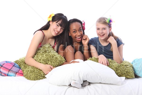 Pyjama party fun for teenage girls in bed at home Stock photo © darrinhenry