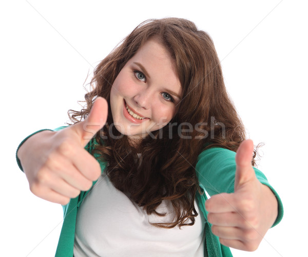 Two thumbs up for success by smiling teenager girl Stock photo © darrinhenry