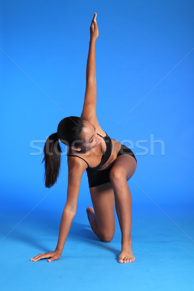 Fitness warm up stretch by fit African woman Stock photo © darrinhenry