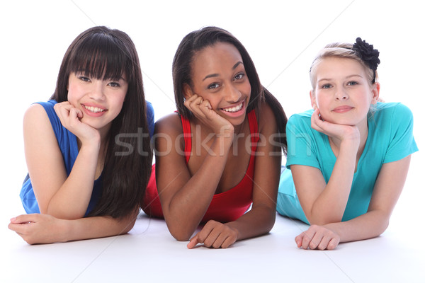 Black white and asian girl friends lying on floor Stock photo © darrinhenry