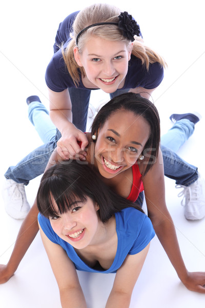 Three mixed race girl friends having fun together Stock photo © darrinhenry