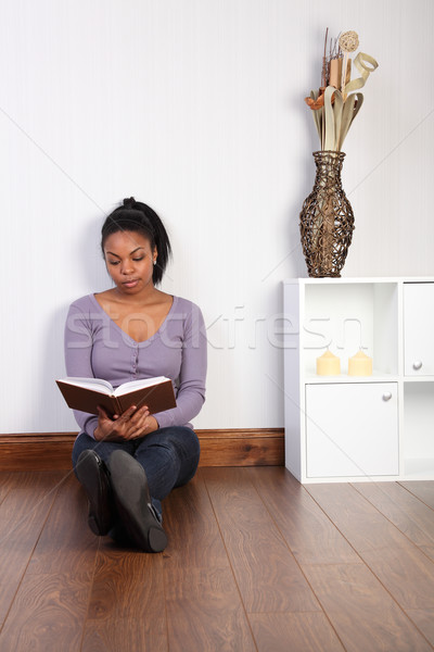 Beautiful woman relaxing at home reading a book Stock photo © darrinhenry