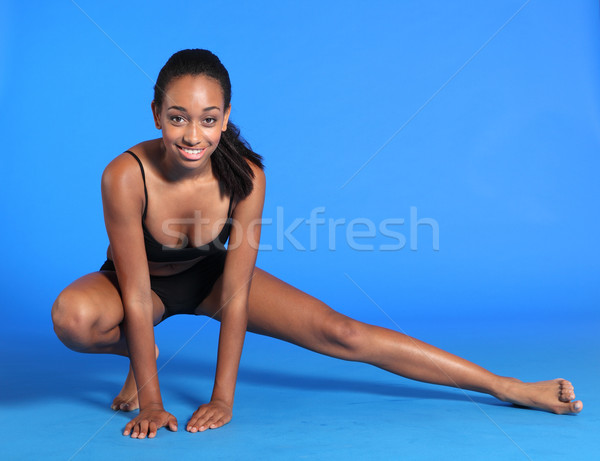Squatting leg stretch exercise by fit young woman Stock photo © darrinhenry