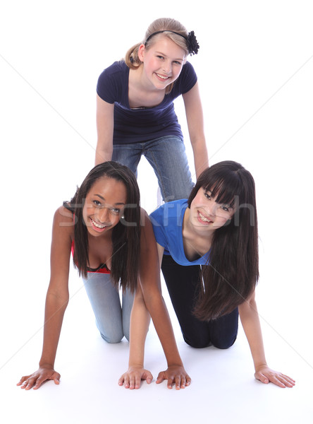 Mixed race teenage girl friends in fun pyramid Stock photo © darrinhenry