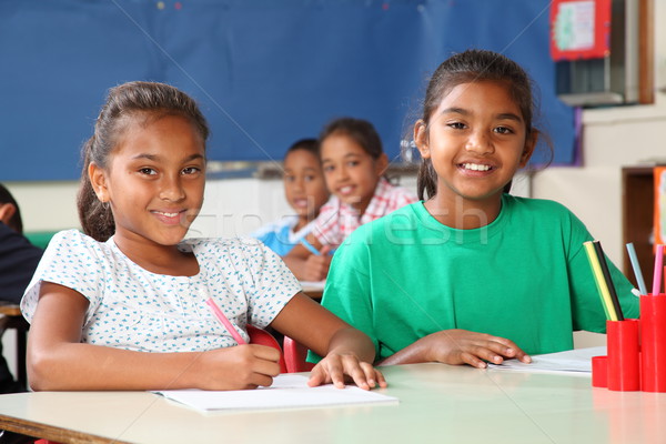 Time to learn for two cheerful school girls in classroom Stock photo © darrinhenry