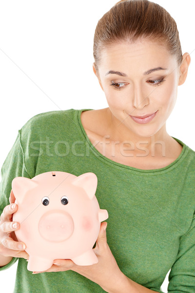 Woman giving her piggy bank a speculative look Stock photo © dash