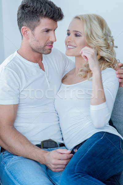 Young couple cuddling on a sofa Stock photo © dash