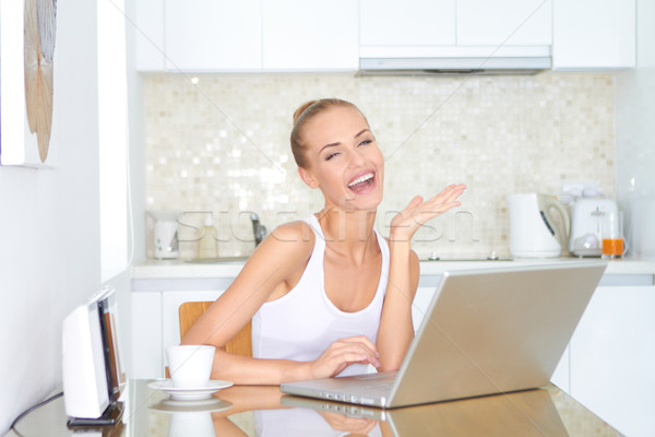 Laughing woman sitting at laptop computer Stock photo © dash