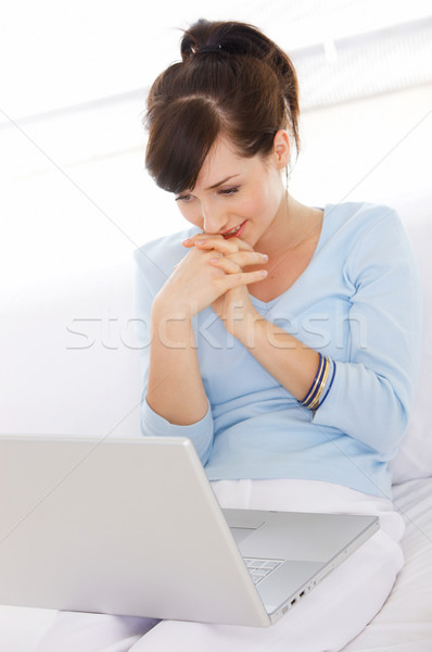 Pretty Young Woman on Couch Using Laptop Stock photo © dash