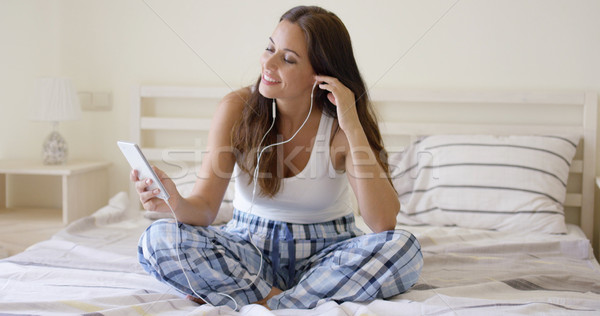 Smiling pretty woman listening to music at home Stock photo © dash