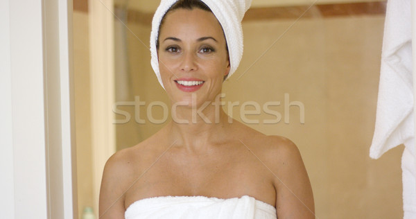 Woman standing at shower stall wrapped in towels Stock photo © dash