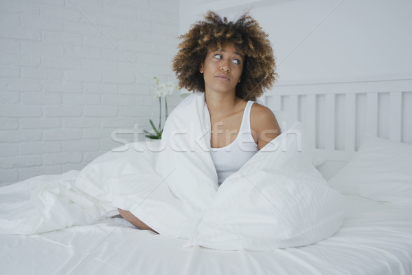 Upset woman cuddling in bed Stock photo © dash