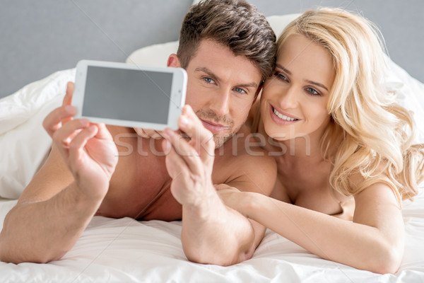 Middle Age Sweet Lovers Taking Photos on Bed Stock photo © dash