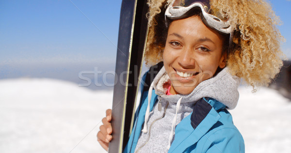 Thoughtful young woman standing holding her skis Stock photo © dash