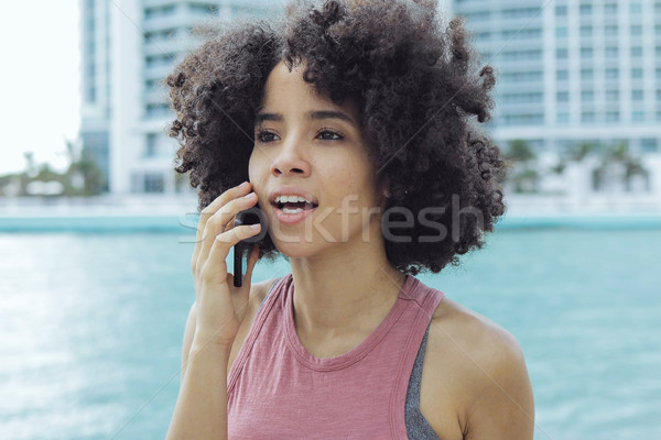 Black girl having phone call on seafront Stock photo © dash