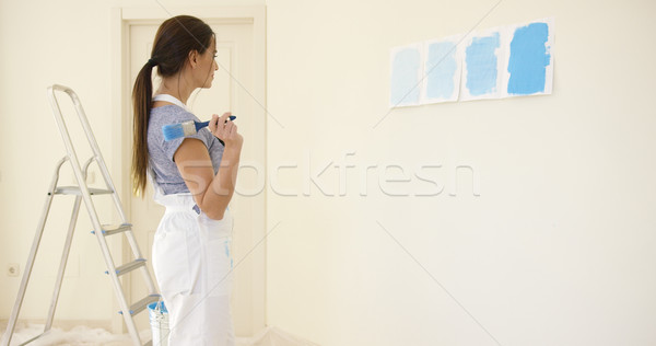 Young woman choosing a shade of blue paint Stock photo © dash