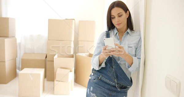 Young woman doing renovations checking messages Stock photo © dash