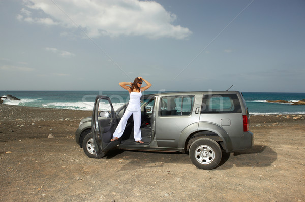 Menina carro mulher praia nuvens mar Foto stock © dash