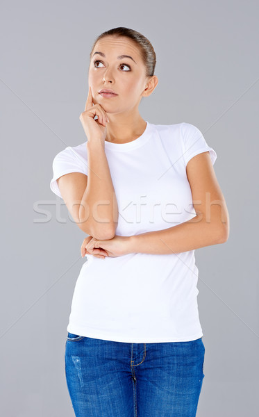 Attractive thoughtful young woman Stock photo © dash