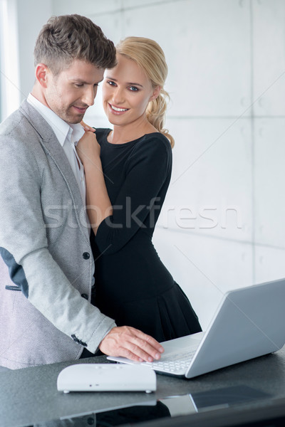 Lovers in Trendy Attire Testing Displayed Laptop Stock photo © dash
