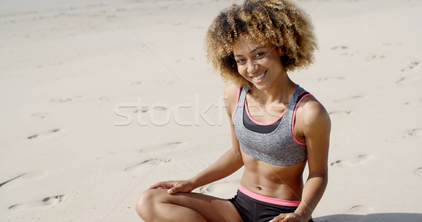 Woman In Sporty Outfit Sits On The Sand Stock photo © dash
