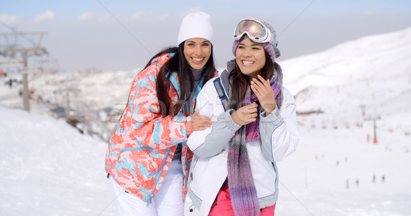 Two happy playful young ladies at a ski resort Stock photo © dash