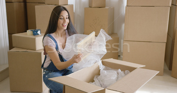 Stock photo: Smiling happy woman packing up her home