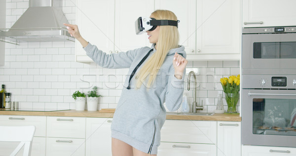 Woman in VR glasses in kitchen Stock photo © dash