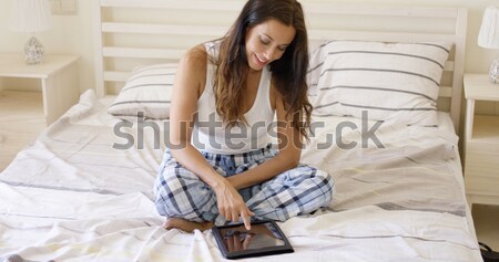 Csinos mosolyog szexi nő ül ágy fekete Stock fotó © dash