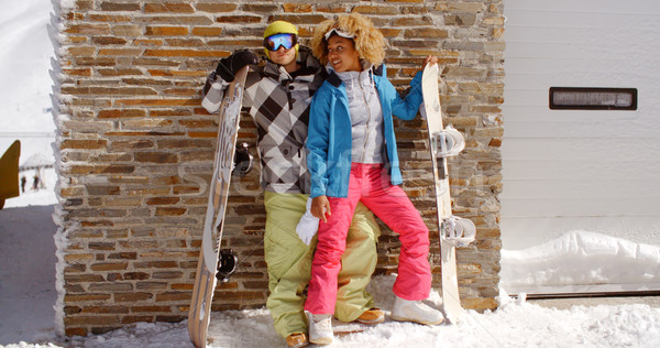Close couple posing with snowboards against garage Stock photo © dash