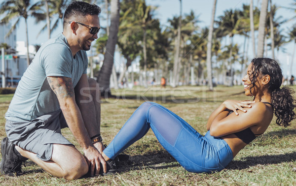 Stock photo: Man supporting girl with abs training