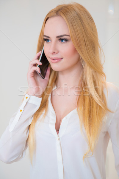 Pretty Woman in White Calling Through Mobile Phone Stock photo © dash