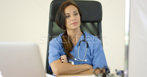 Stock photo: Serious female doctor at laptop computer