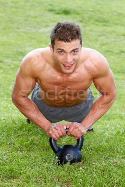 Stock photo: Muscular man working out on green grass