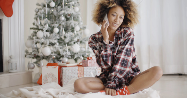 Young woman relaxing in front of a Christmas tree Stock photo © dash